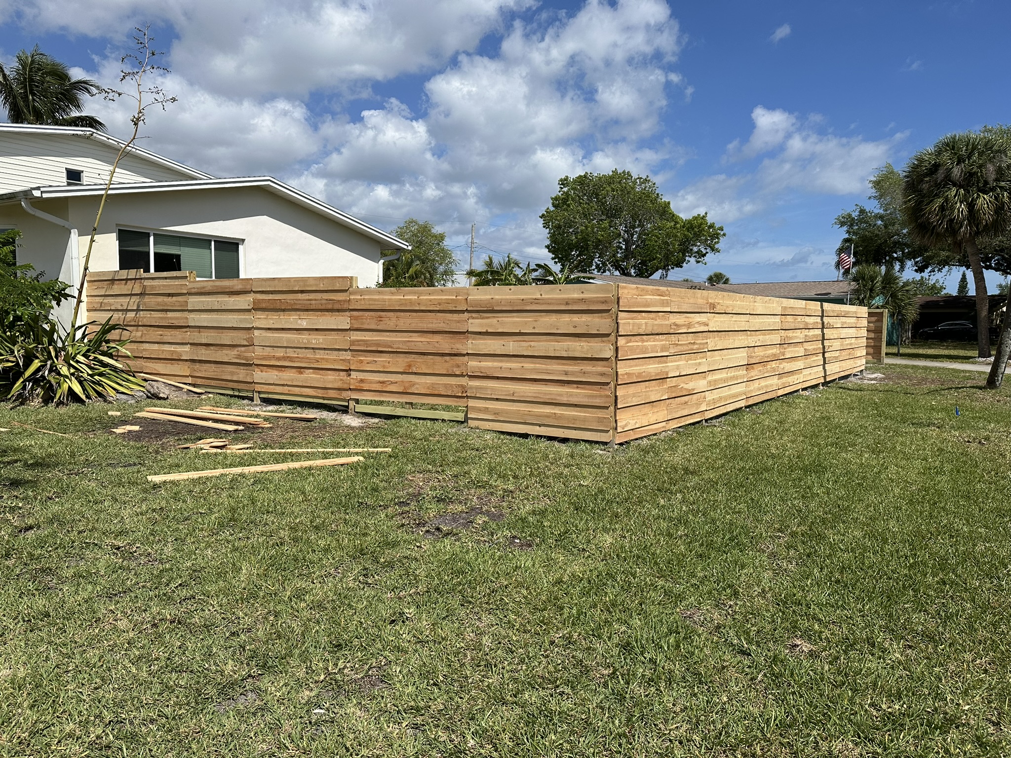 The completed horizontal-board fence around Drew's yard in Indian Harbour Beach, Florida