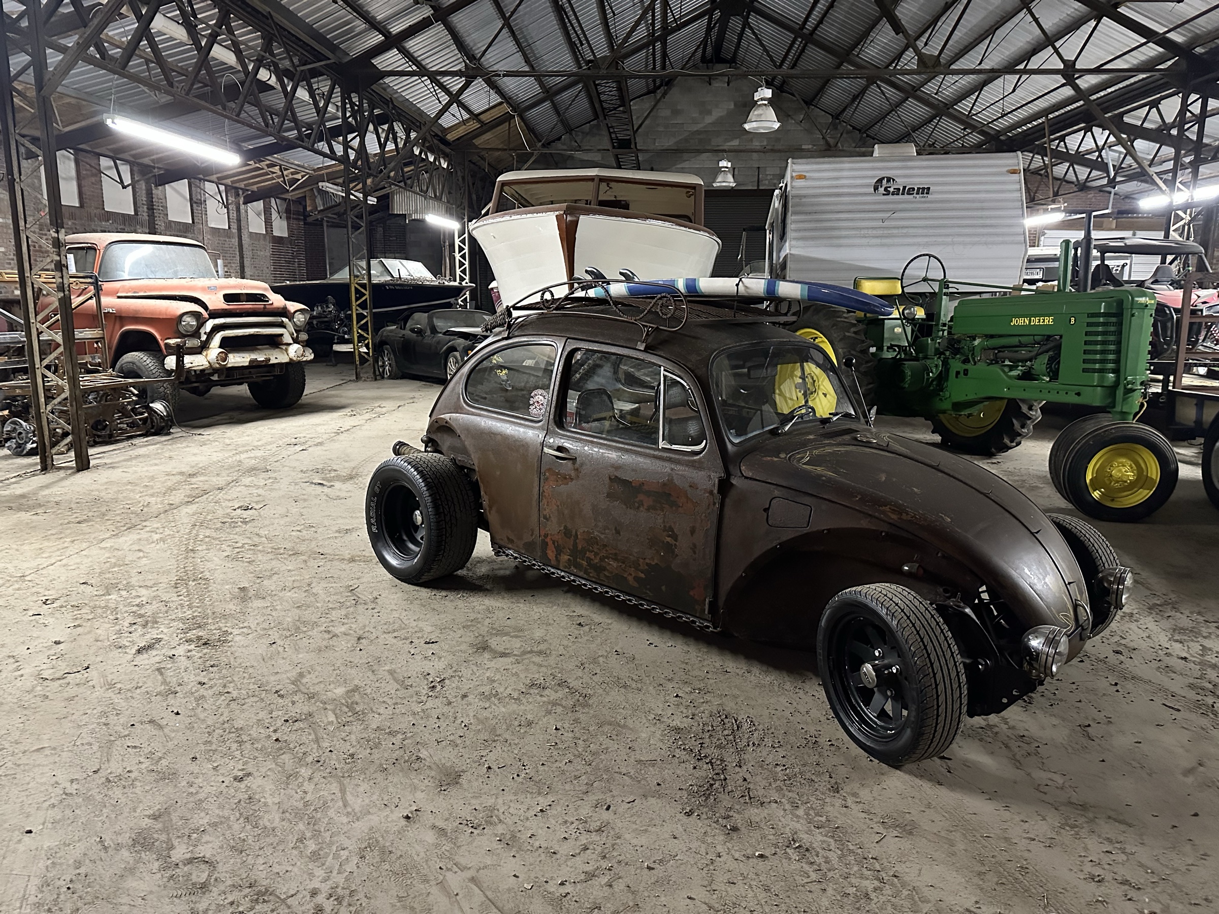 Eric's warehouse filled with vehicles, machinery, tools, and projects