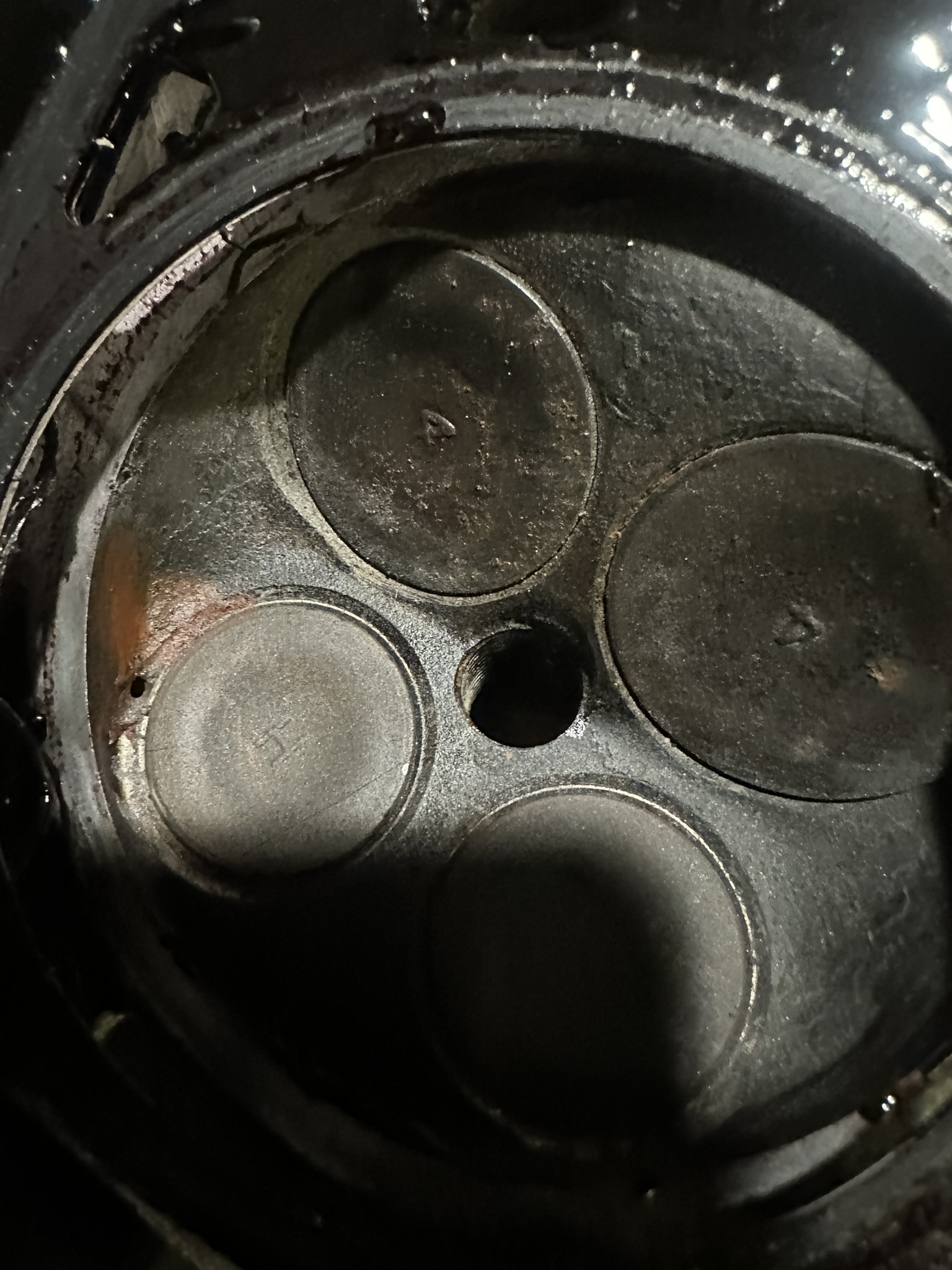 The pinhole in the Honda cylinder head beside the combustion chamber