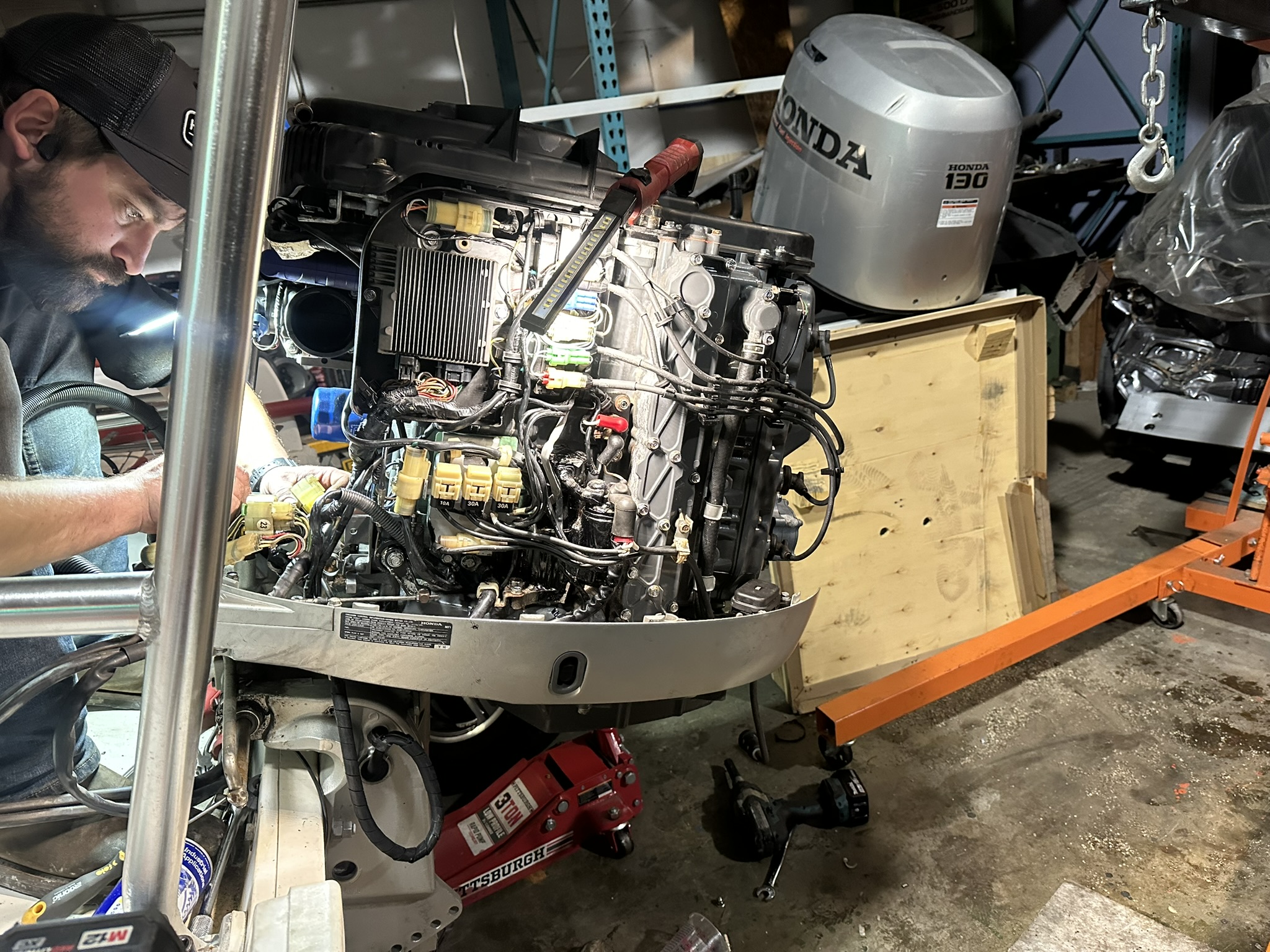 Brendan working on the disassembled Honda BF130 during the powerhead installation