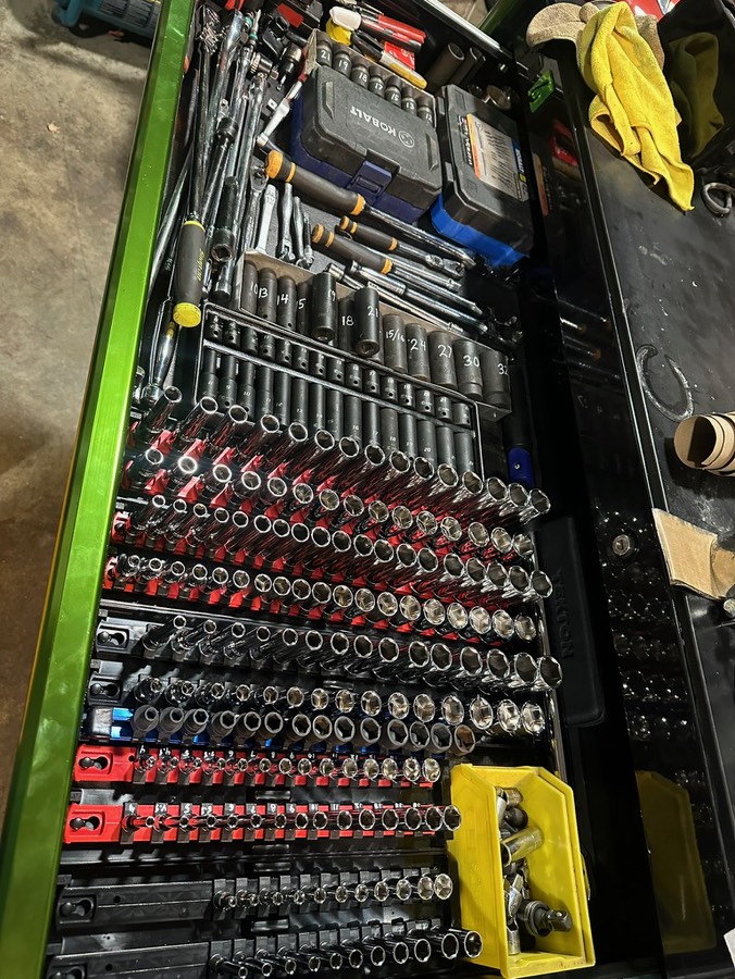 An organized drawer of sockets, ratchets, wrenches, and specialty tools